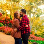 a man and a woman kissing in a garden