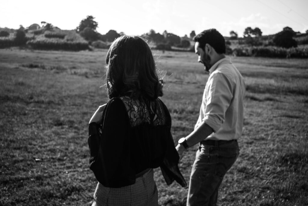 a man and a woman standing in a field