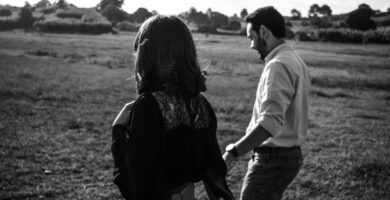 a man and a woman standing in a field