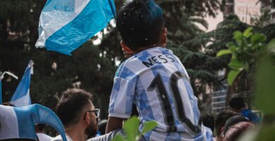 a young boy holding a blue and white flag