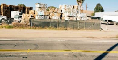 brown and white boxes beside wide road