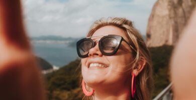 woman in white tank top wearing black sunglasses